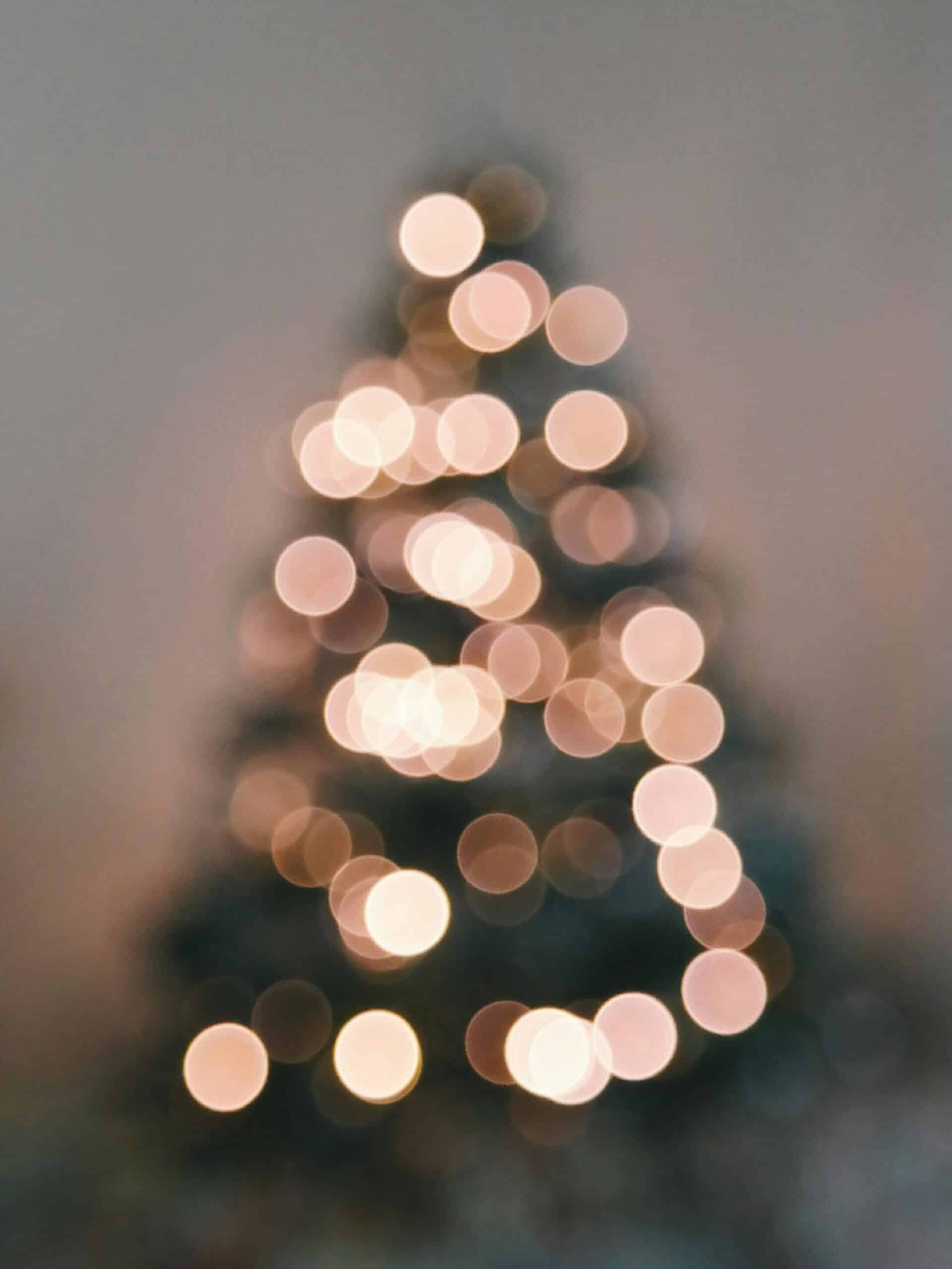 An image of a christmas tree with lights, the lights are blurred and the image is not in focus.
